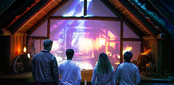 Four guests watching the FlyOver Iceland preshow experience.