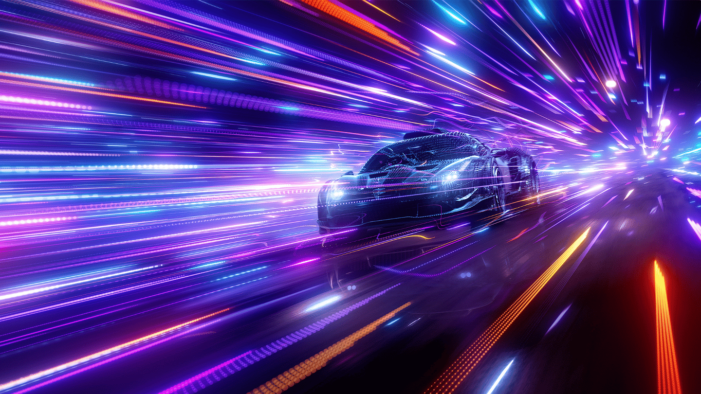 A racecar picking up speed as it races forward wrapped in neon lights.