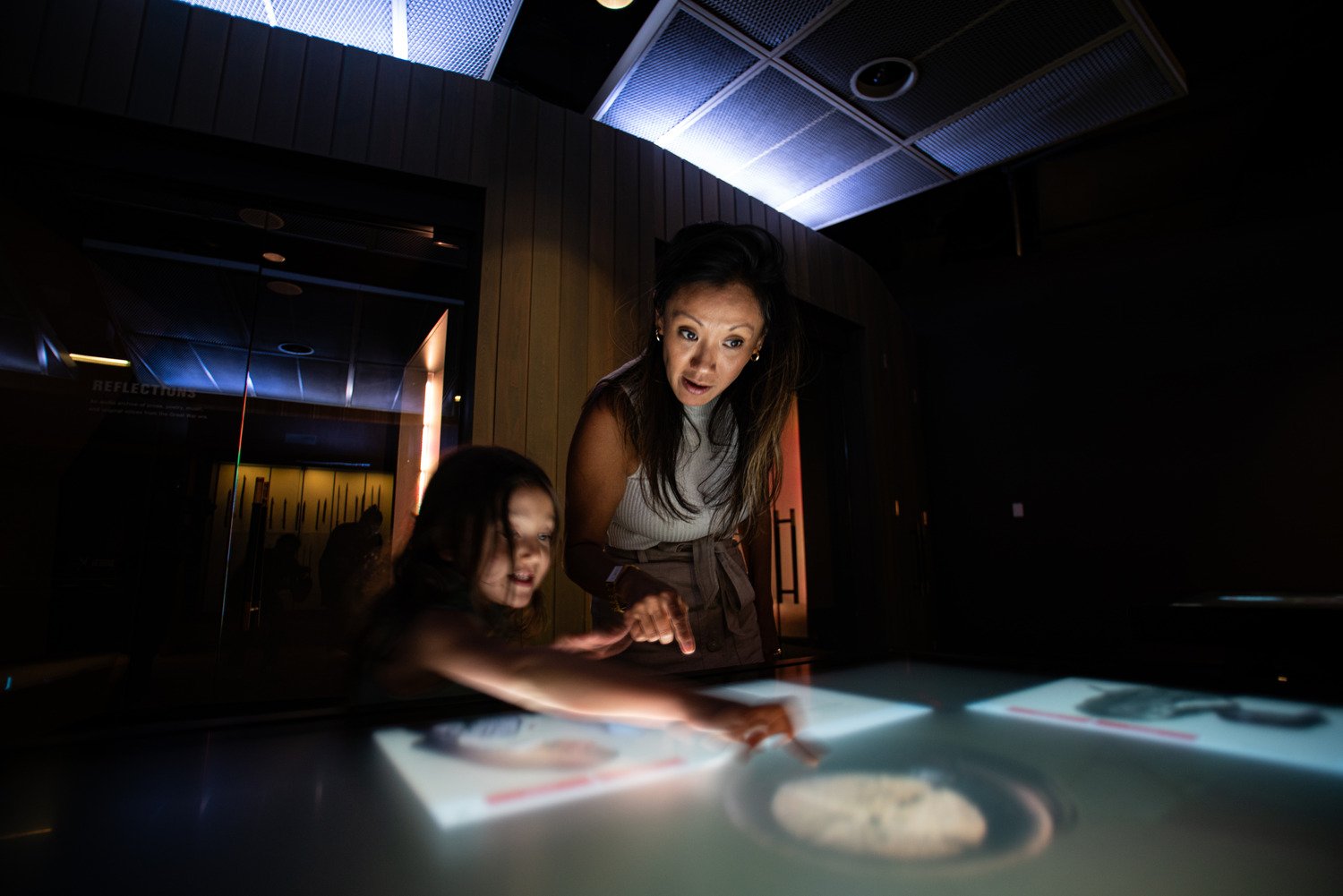 Two visitors to the National WWI Museum and Memorial engaging with a touch table.